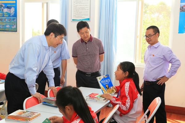 在安宁镇中心校与正在阅览室阅读的孩子们亲切交流.JPG